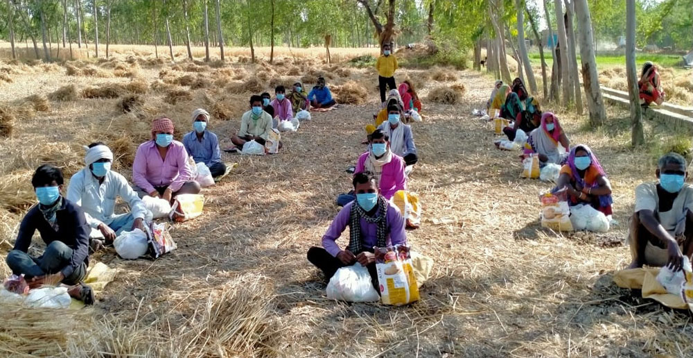 Pavitramenthe Workers sitting in fields with masks during the Covid-19 Pandemic